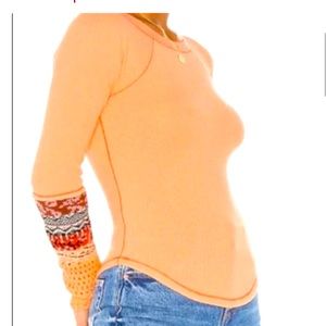 Free People peachy orange long sleeved top with crochet work on arms. Excellent